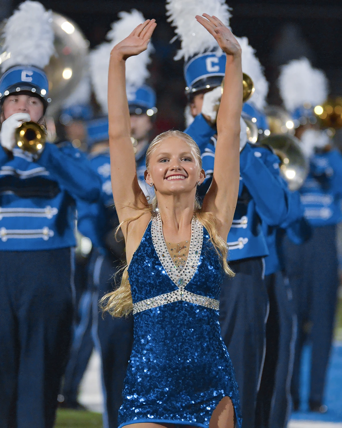 Woman posing with band members behind her