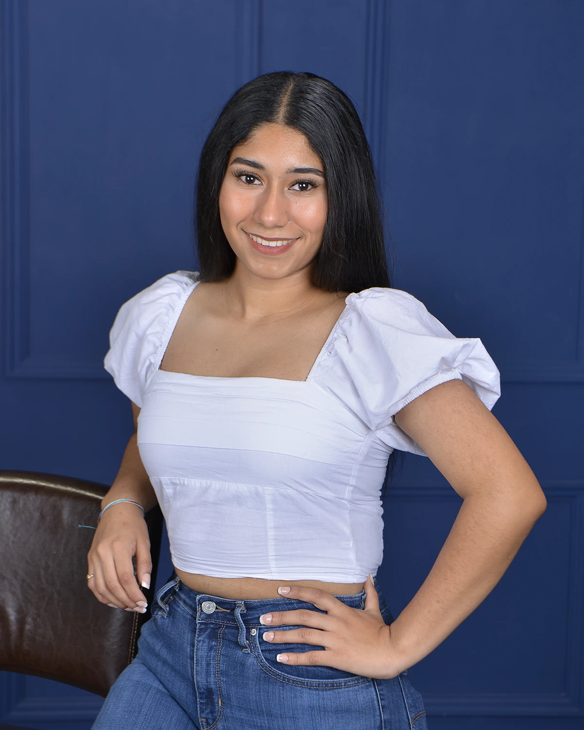 Casual portrait of young woman on blue backdrop