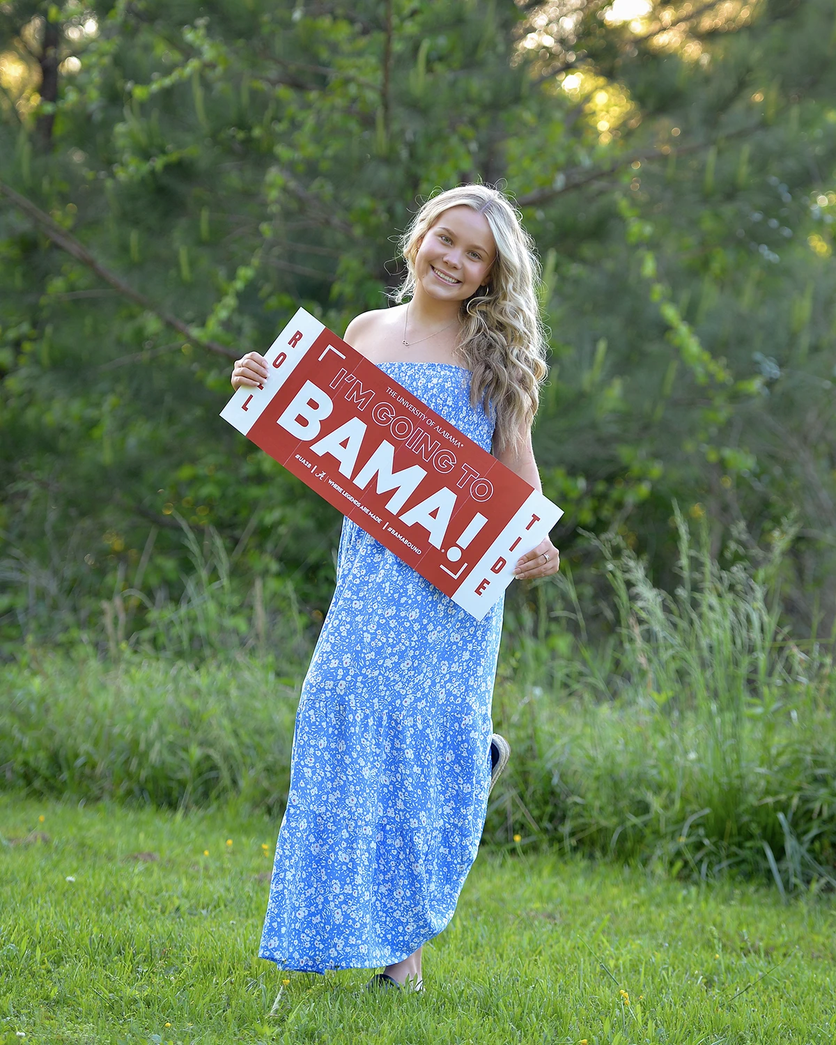 Outside portrait of woman holding Bama sign