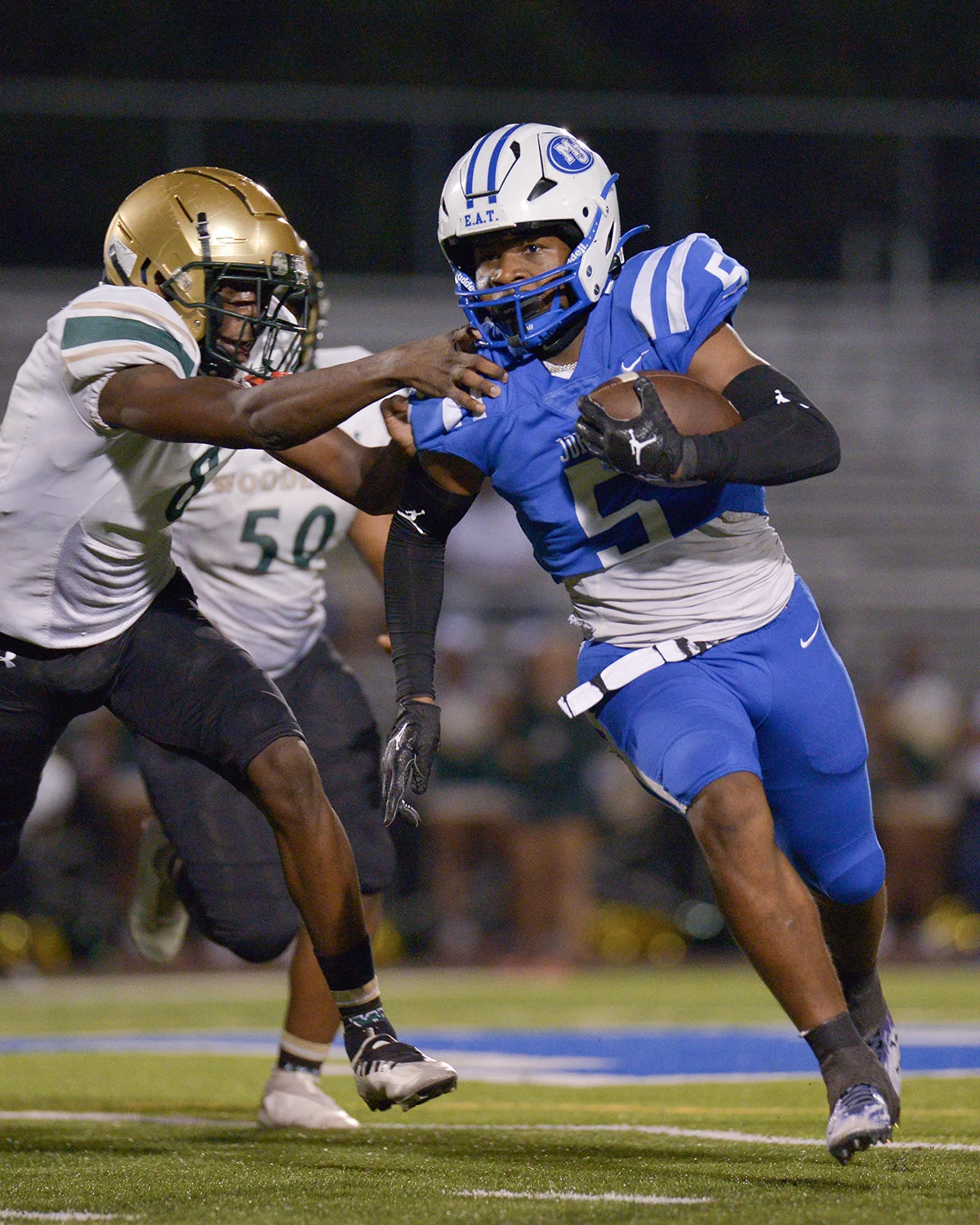 A football player blocking a tackle