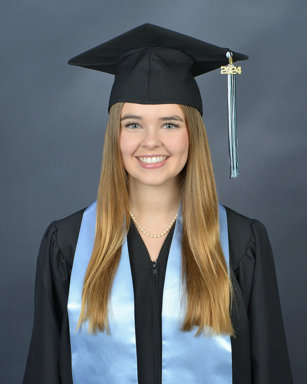 Senior portrait of woman in cap and gown